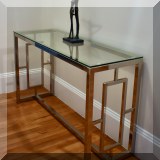 F09. Chrome and glass console table. 28"h x 47"w x 16"d 